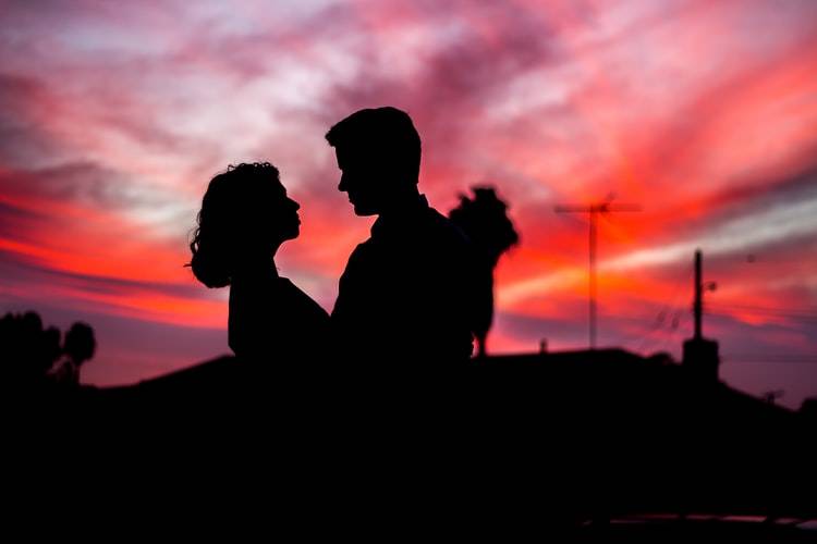 couple staring at one another at sunset
