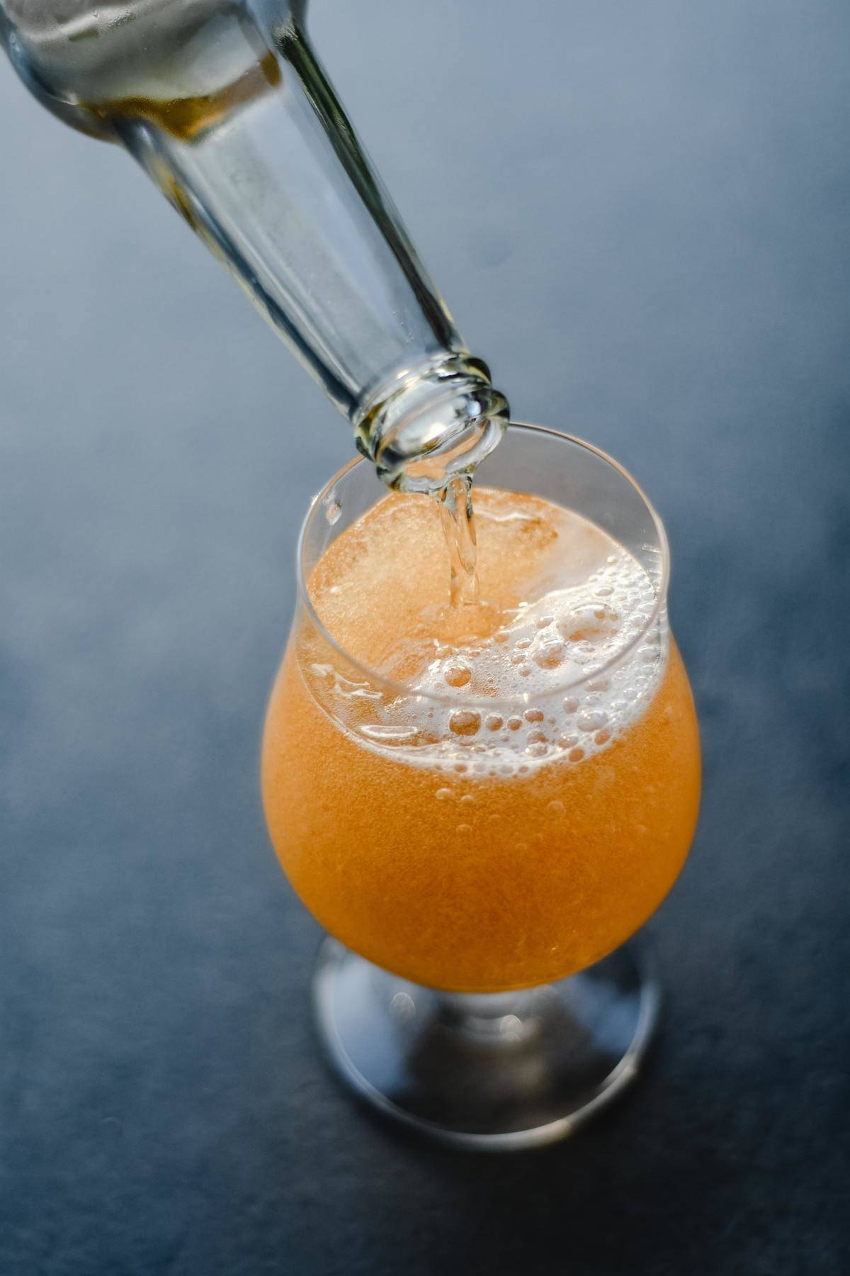 pouring beer into glass from bottle