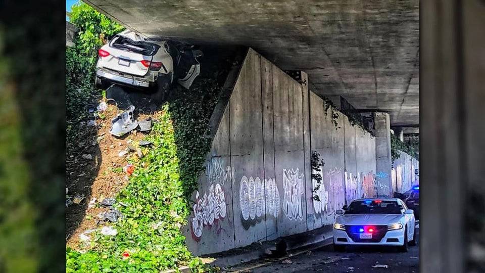 A car stuck underneath an underpass