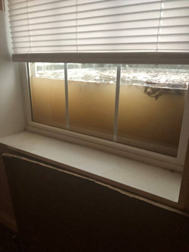 View outside apartment window that shows high level of water that's about to flood the unit