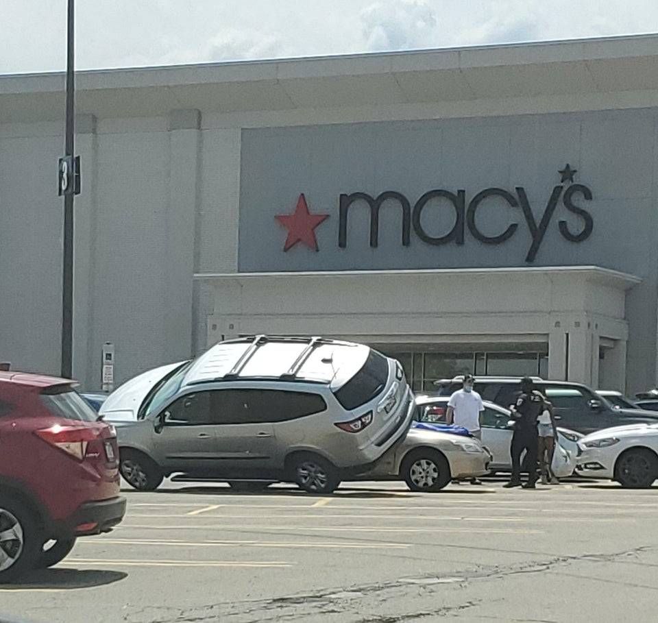 SUV is perched on its side at a Macy's