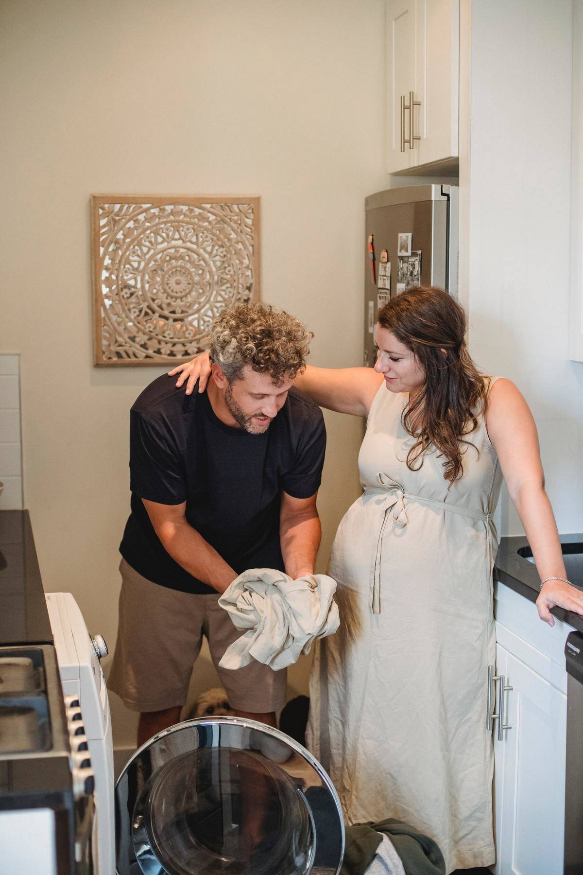 Man helps pregnant wife do the laundry
