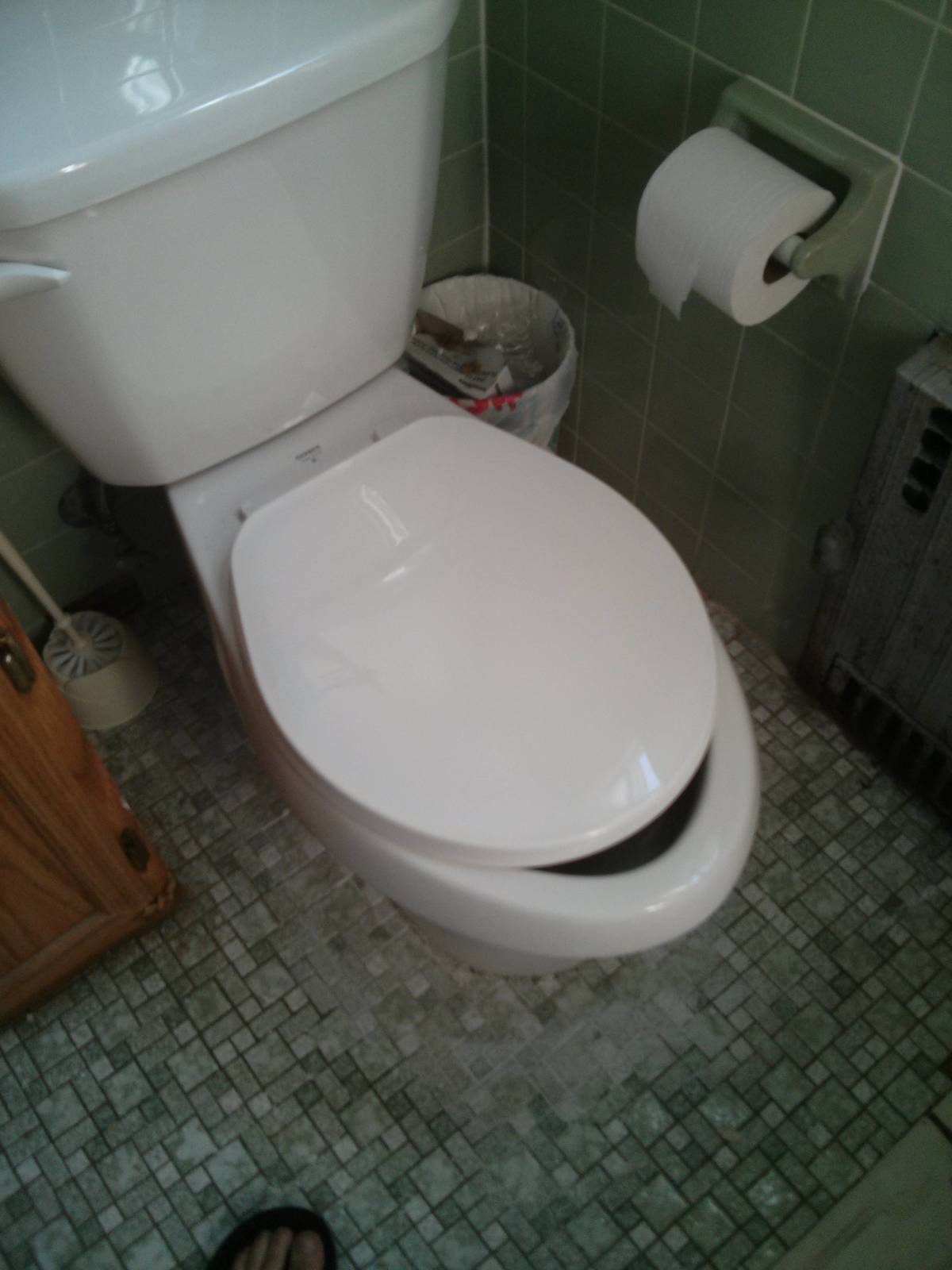 Toilet with seat installed too far back, lid does not close properly