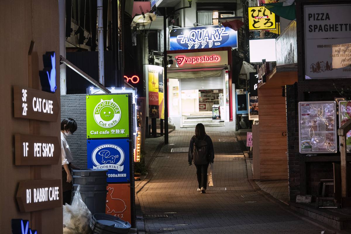 A young woman walks on the deserted street at downtown in Tokyo, Japan, on April 25, 2021.