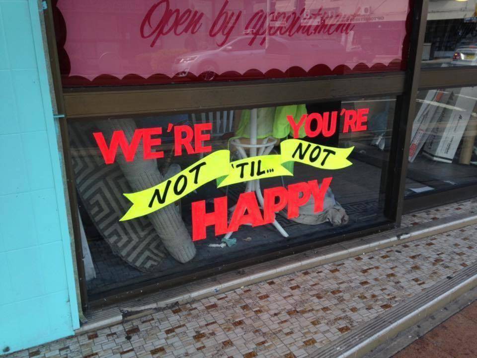 poorly designed ad reads as: we're you're not til not happy