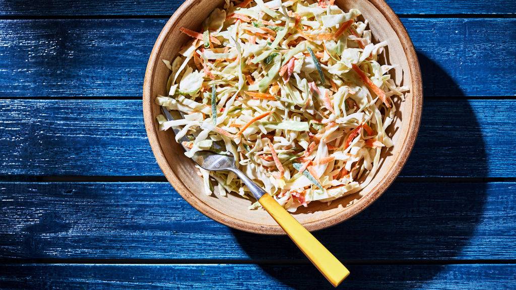 coleslaw in a bowl with a blue wood background