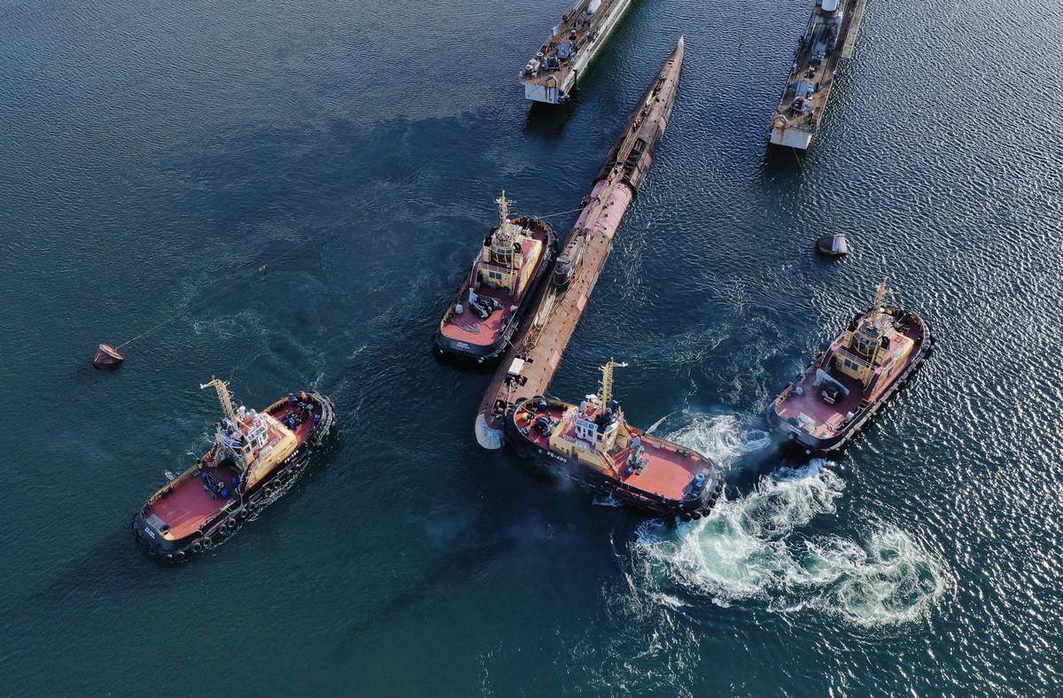 Boats escort the Soviet Union's first nuclear submarine.
