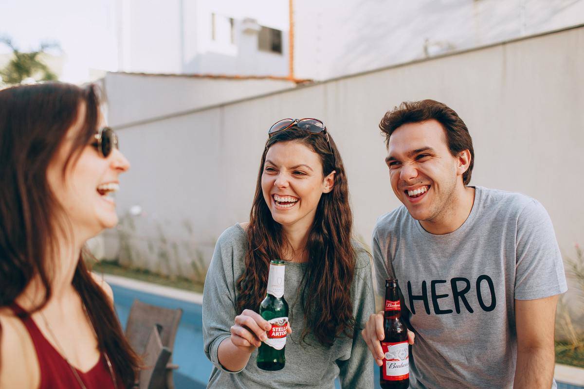 friends have beer while laughing
