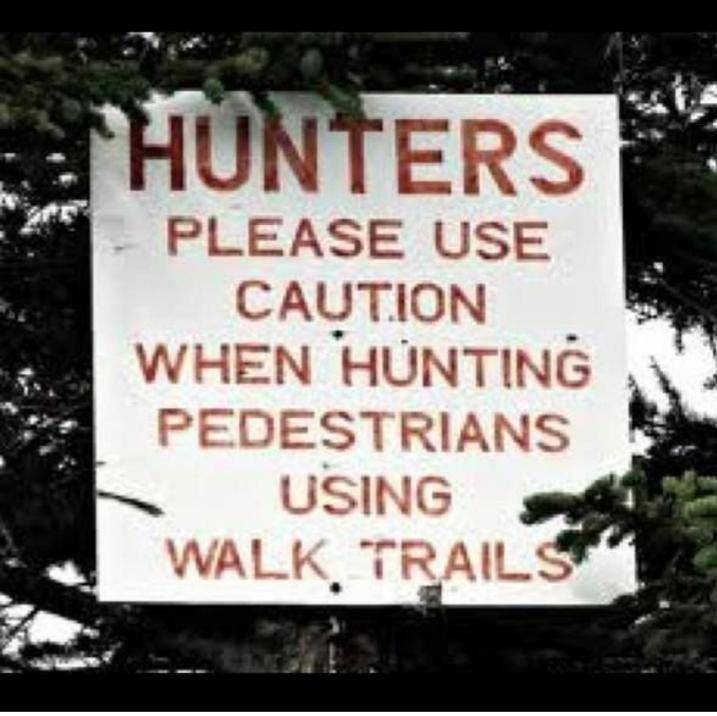 sign in woods: Hunters please use caution when hunting pedestrians using walk trails