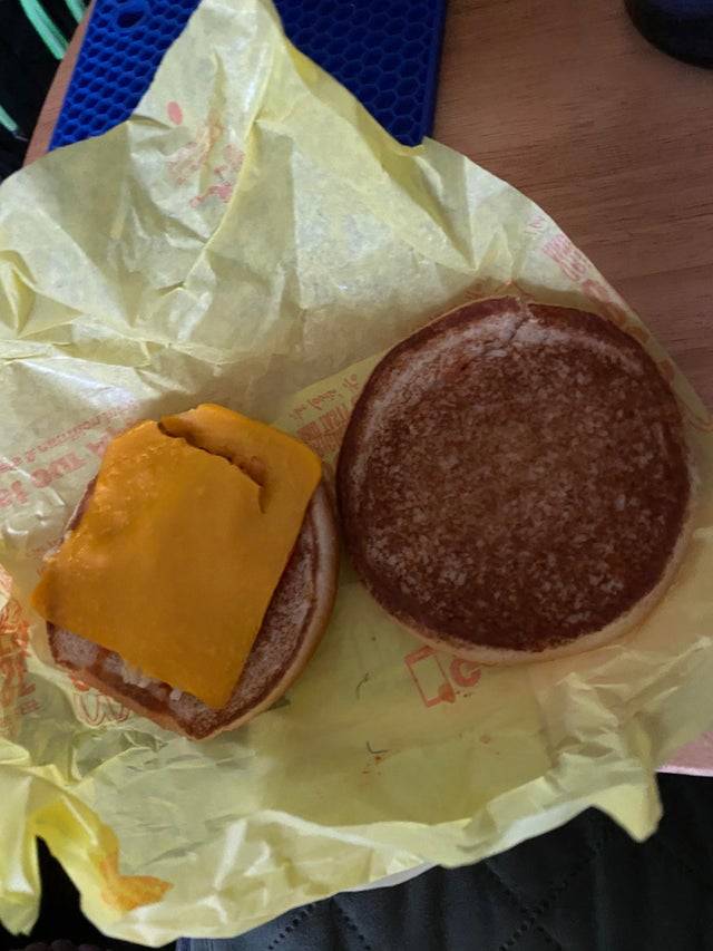 a hamburger bun with only cheese on it