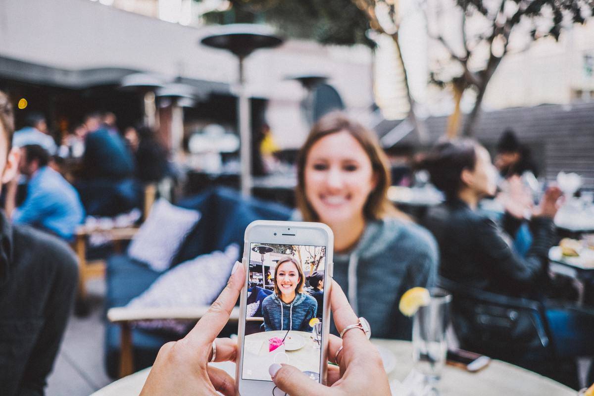 a girl getting her photo taken at an outdoor restaurant