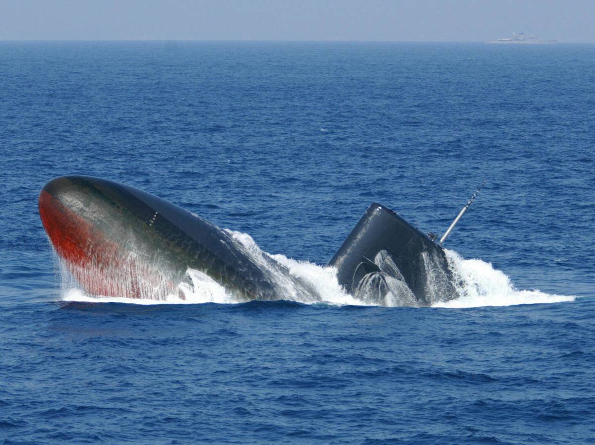 A Japanese submarine rises from the ocean.