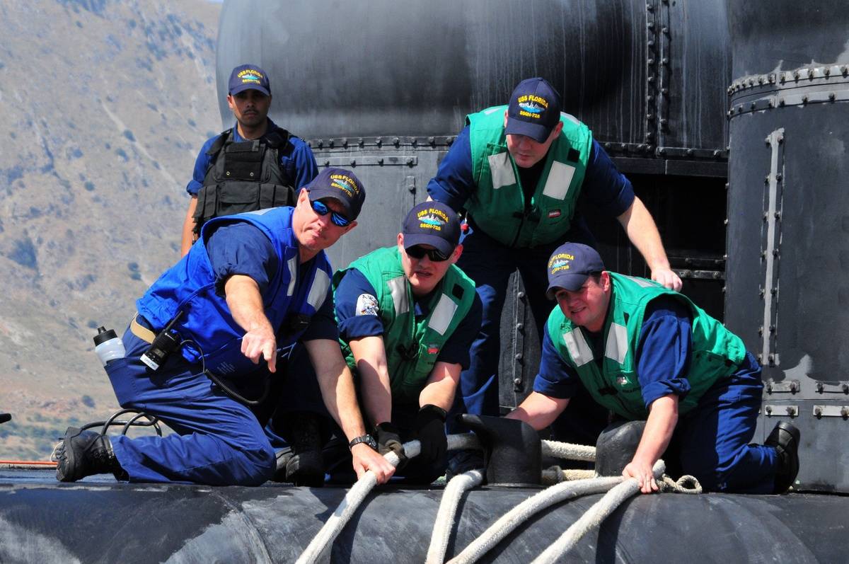 Sailors help work on an Ohio-class submarine.