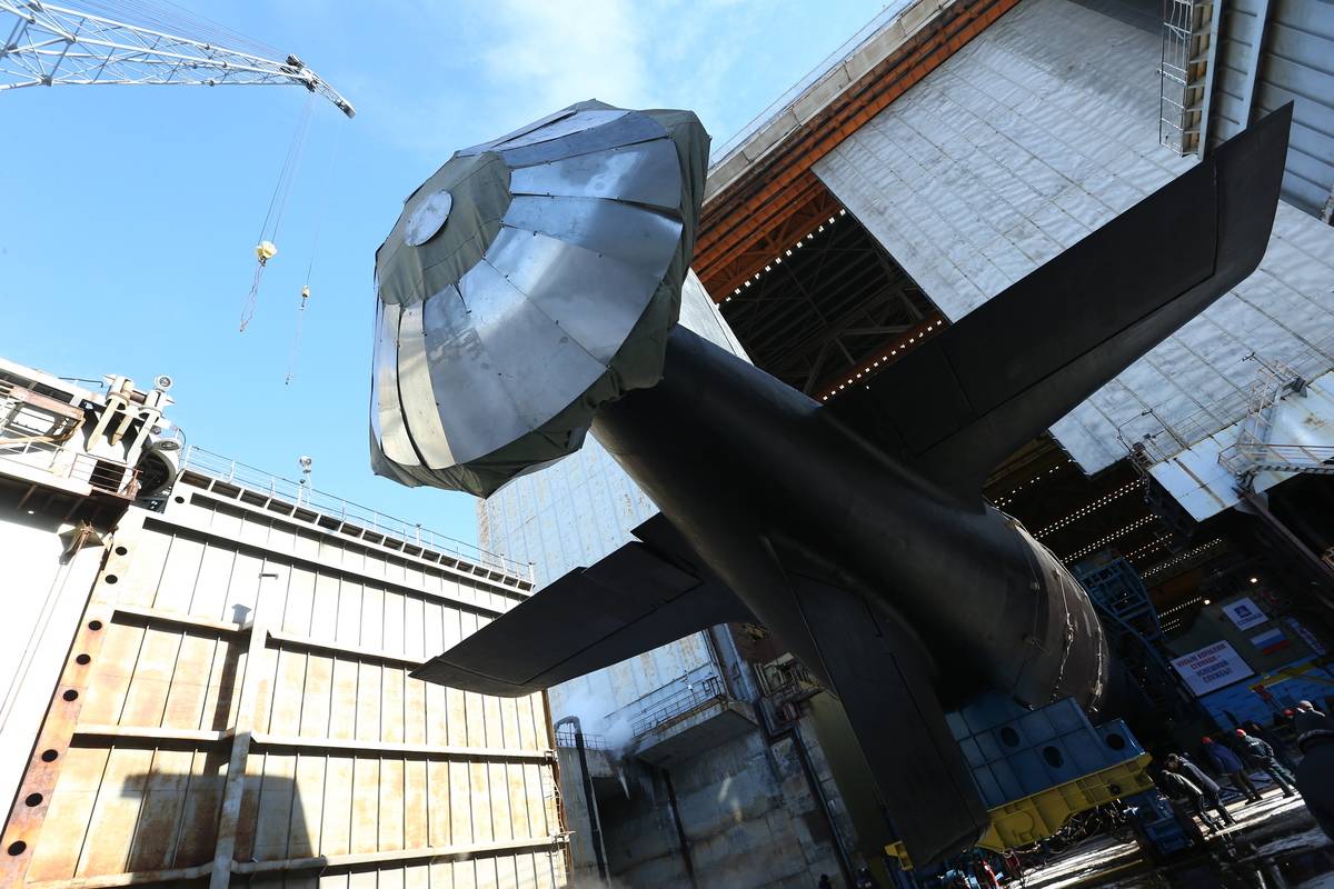 Russia launches the Kazan, a Project 885M Yasen-class nuclear-powered multipurpose attack submarine, from a shipyard.