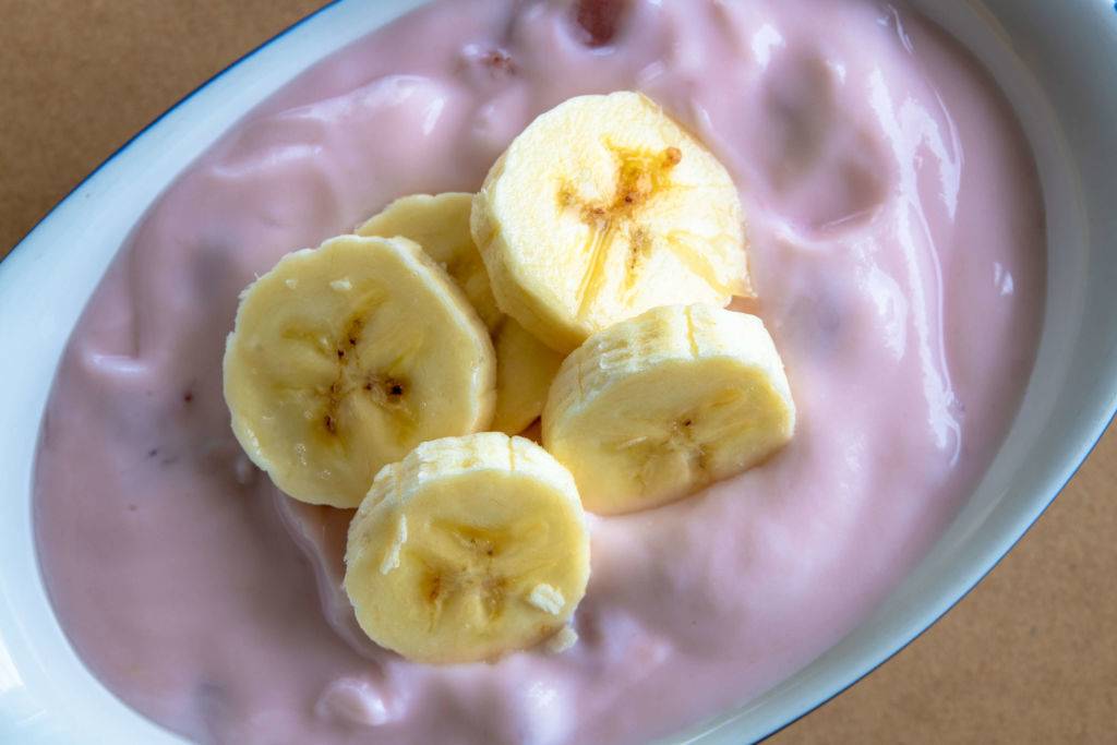 strawberry yogurt with pieces of ripe banana on top