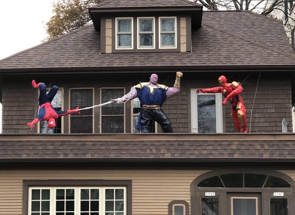 Avengers Halloween decorations fight on house's rooftop 