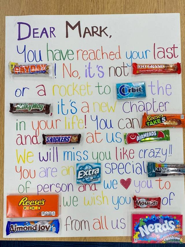 A coworkers retirement gift is a loving message spelled out using a variety of chocolate bars and candy