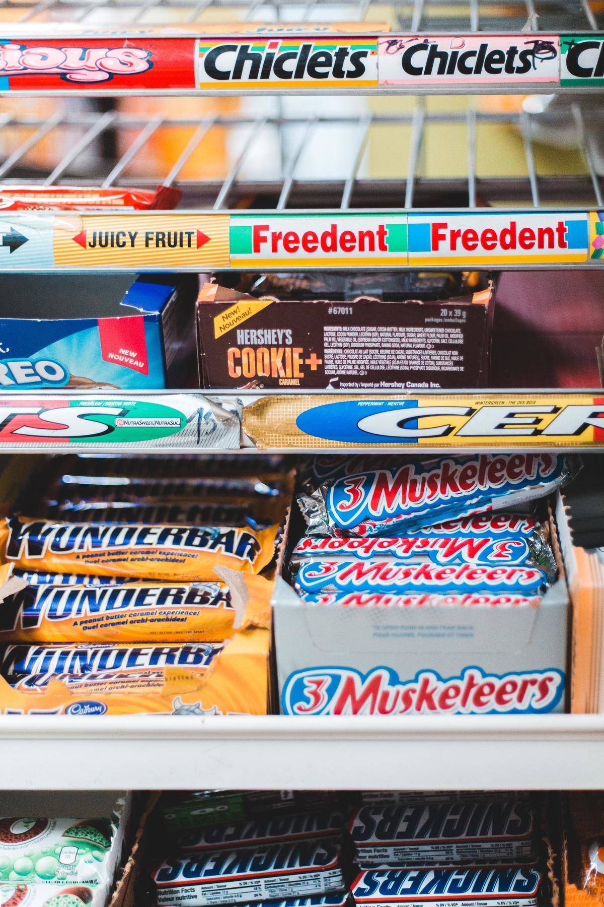 Chocolate bars and other candy seen at a grocery store checkout 