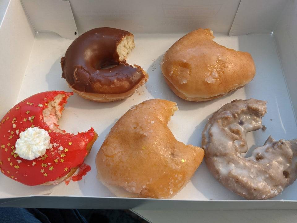 Box of half eaten donuts brought in by a coworker who had just quit her job