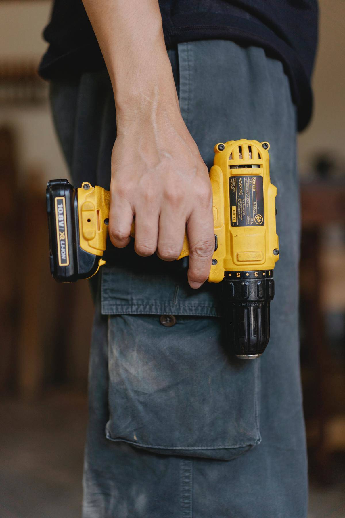 Man holding a yellow drill 