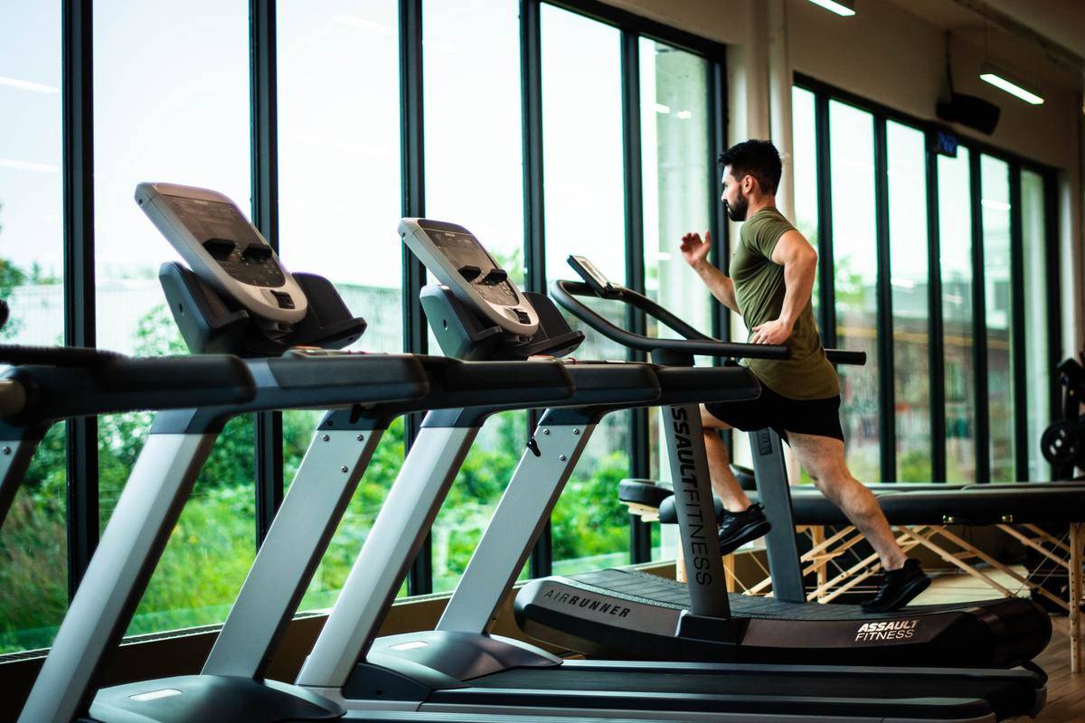 Man runs on a treadmill at the gym