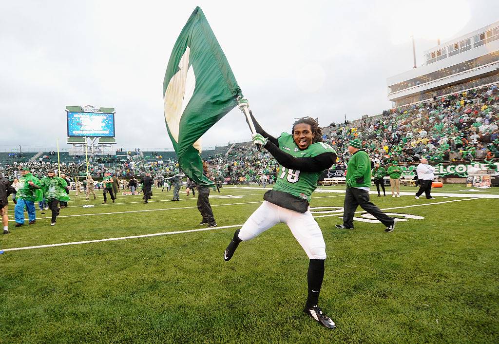 football player waving a flag in Huntington, West Virginia
