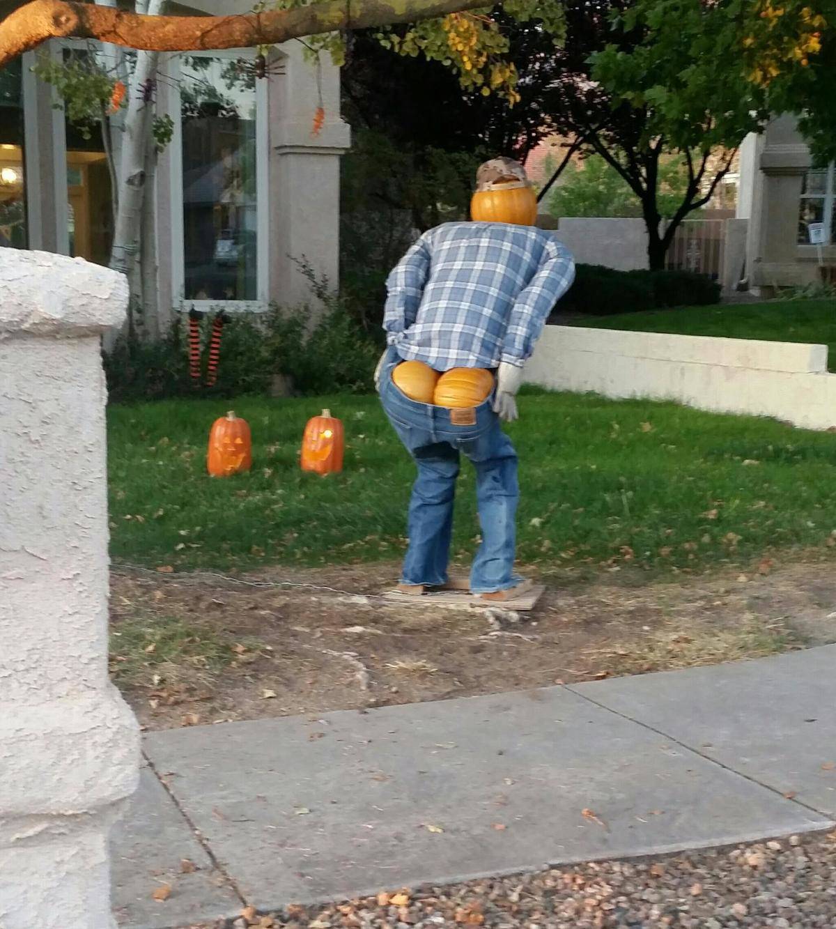 Mooning pumpkin man for Halloween decorations, standing on front lawn