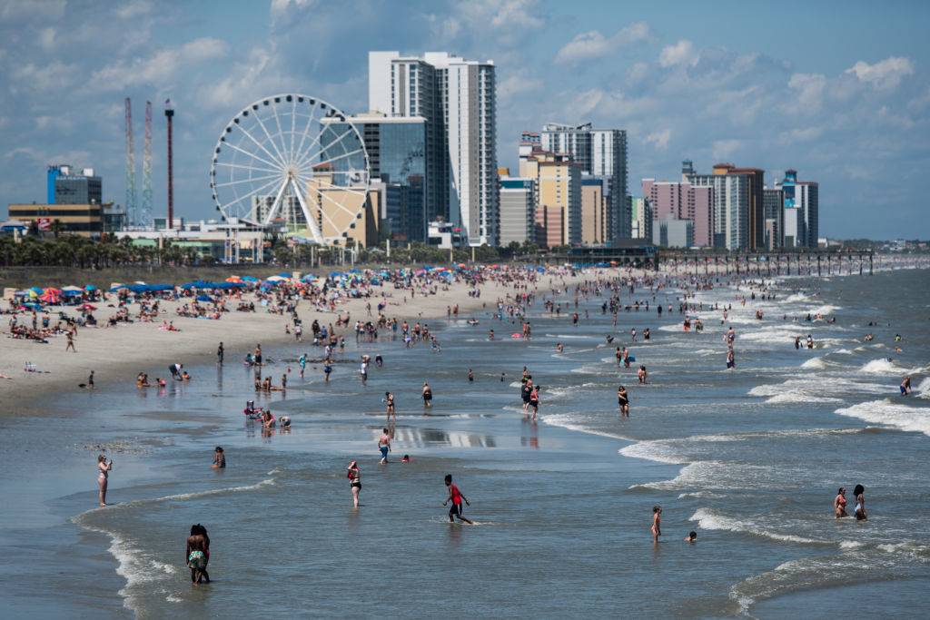 People wade in the surf in Myrtle Beach, South Carolina