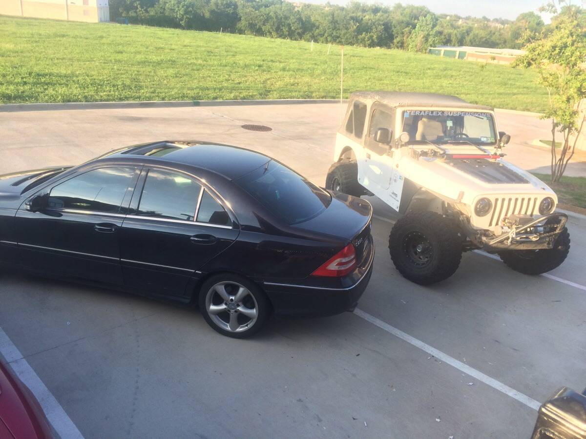 Photo of two employees' poorly parked cars in a company parking lot 