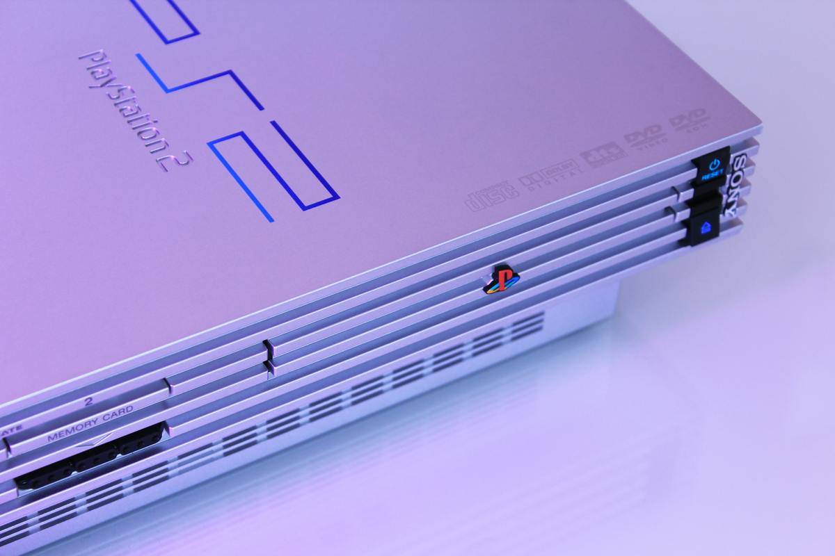 A close-up of a silver Playstation 2 console 