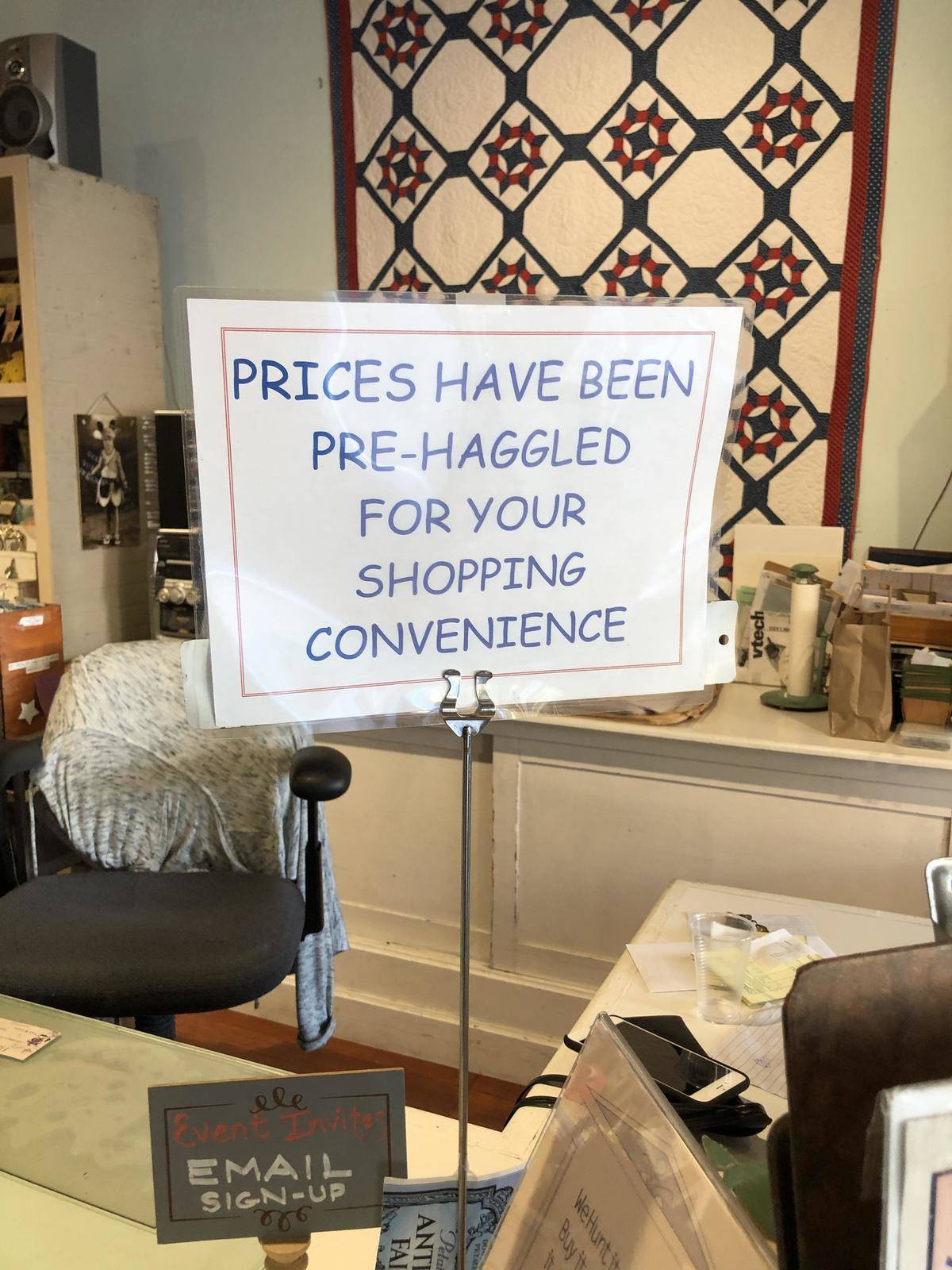 Sign in antiques shop says prices are pre-haggled