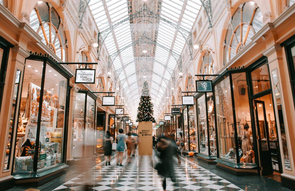 People walk through a luxury shopping mall during the holiday season