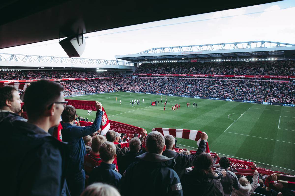 Crowd of spectators watching a soccer game during an outdoor match