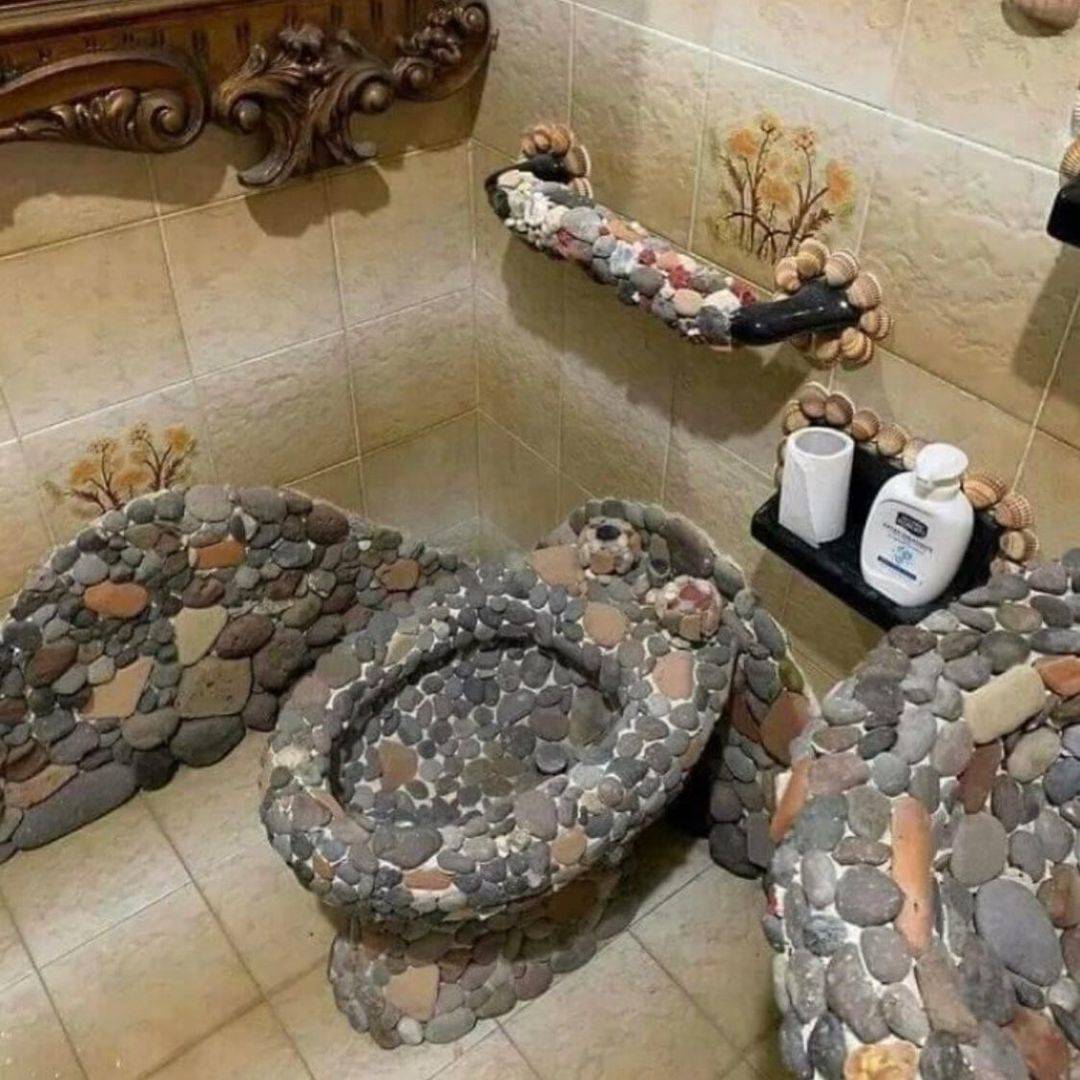 Stone toilet, stone sink, and stone towel holder in bathroom