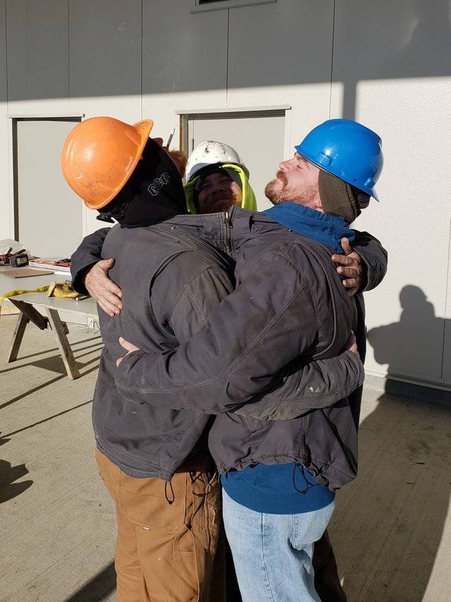 Three coworkers show up to work wearing the same coat and decided to zip themselves up together and hug