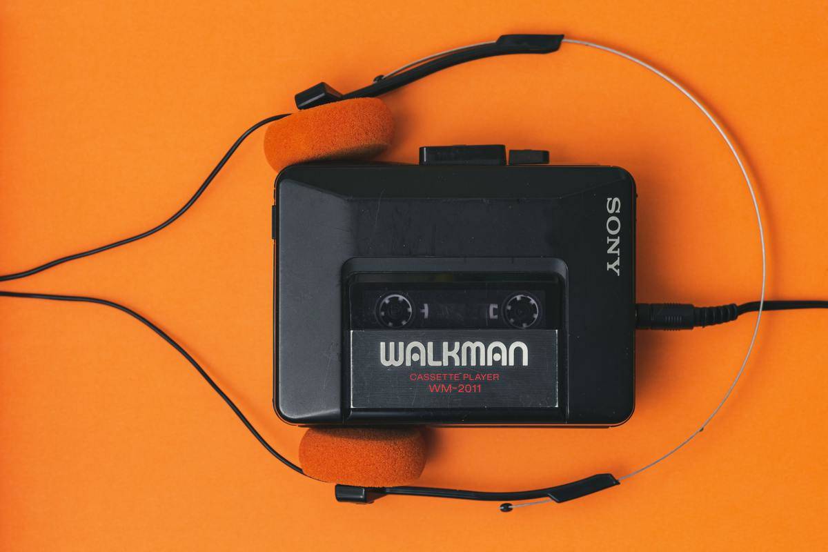 Sony Walkman cassette player against an orange background