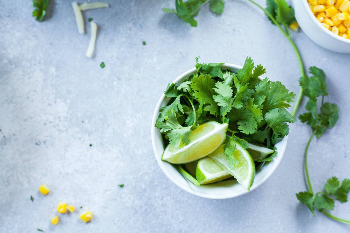 a bowl with cilantro and limes