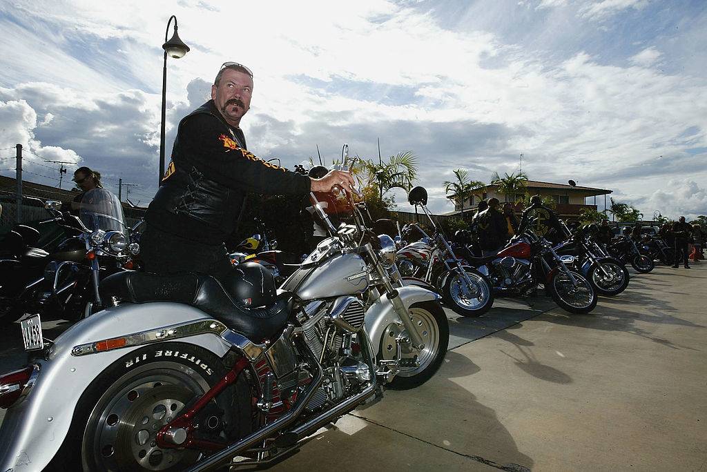 a Bandidos club member parking his motorcycle