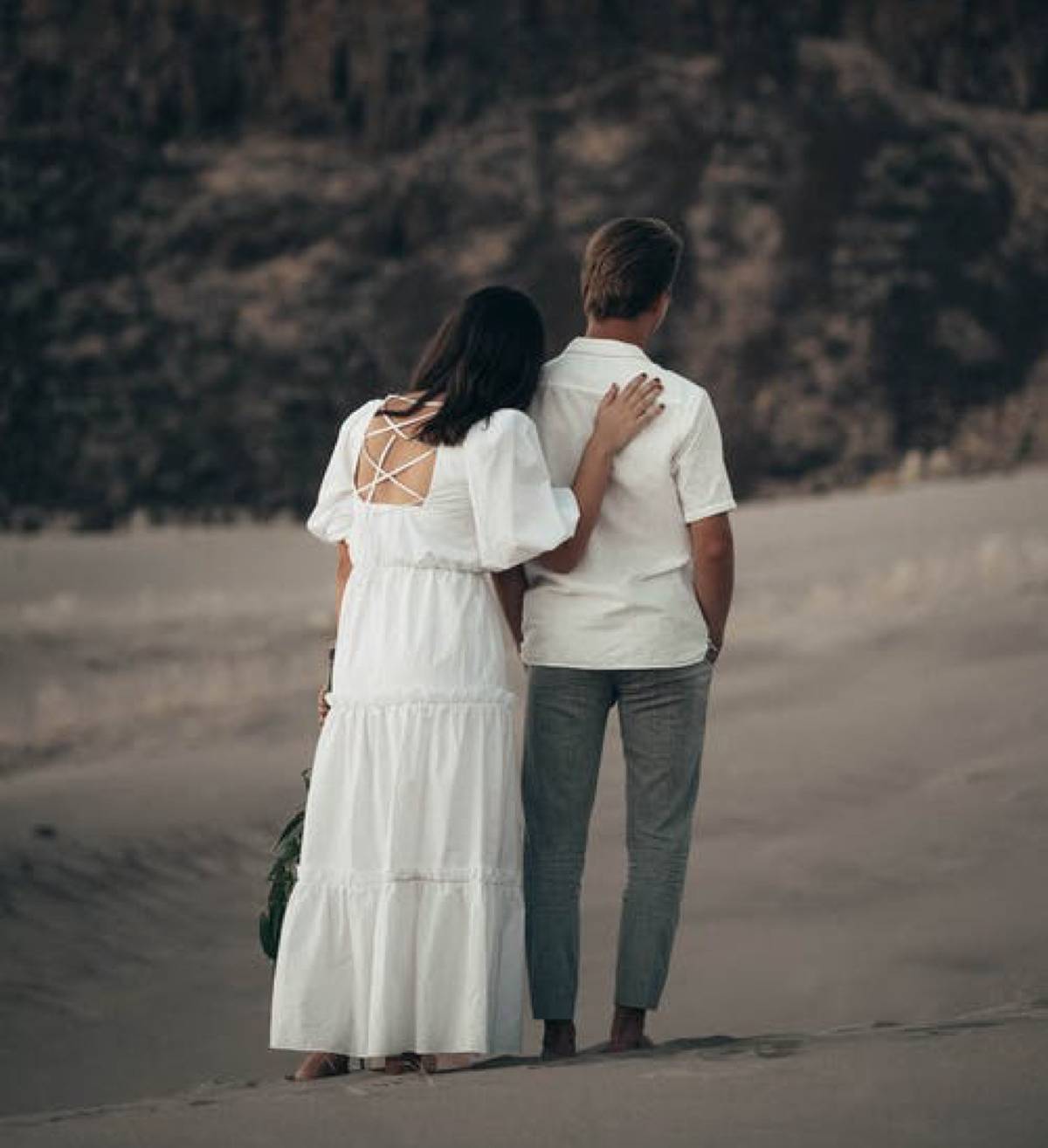 couple walking outside dressed in white