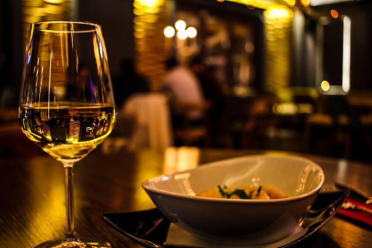 wine glass and meal at restaurant