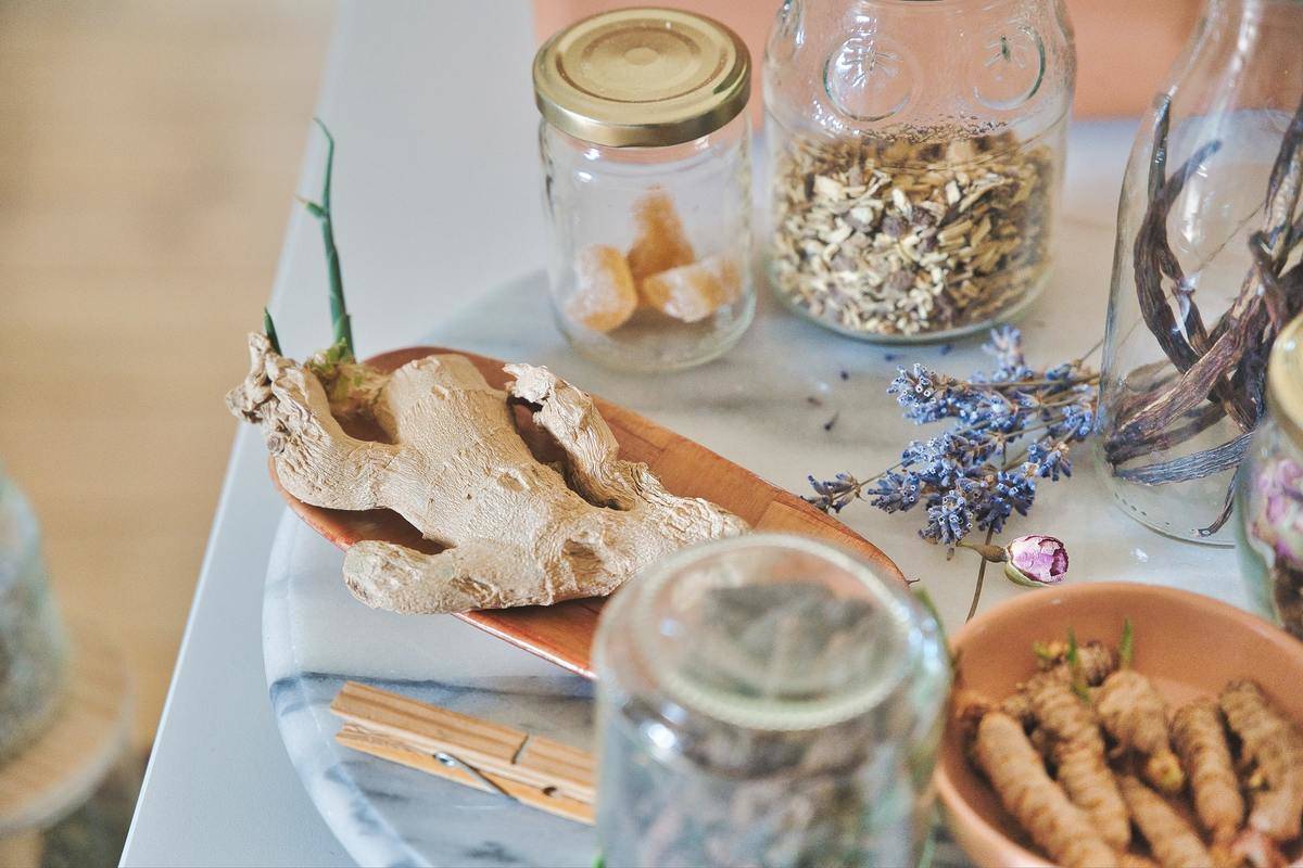 Fresh ginger sits next to a variety of herbs.