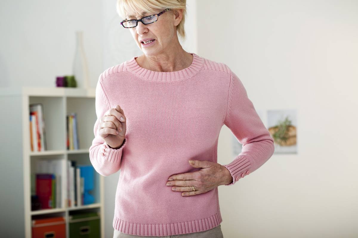 An older women experiences menstrual cramps.