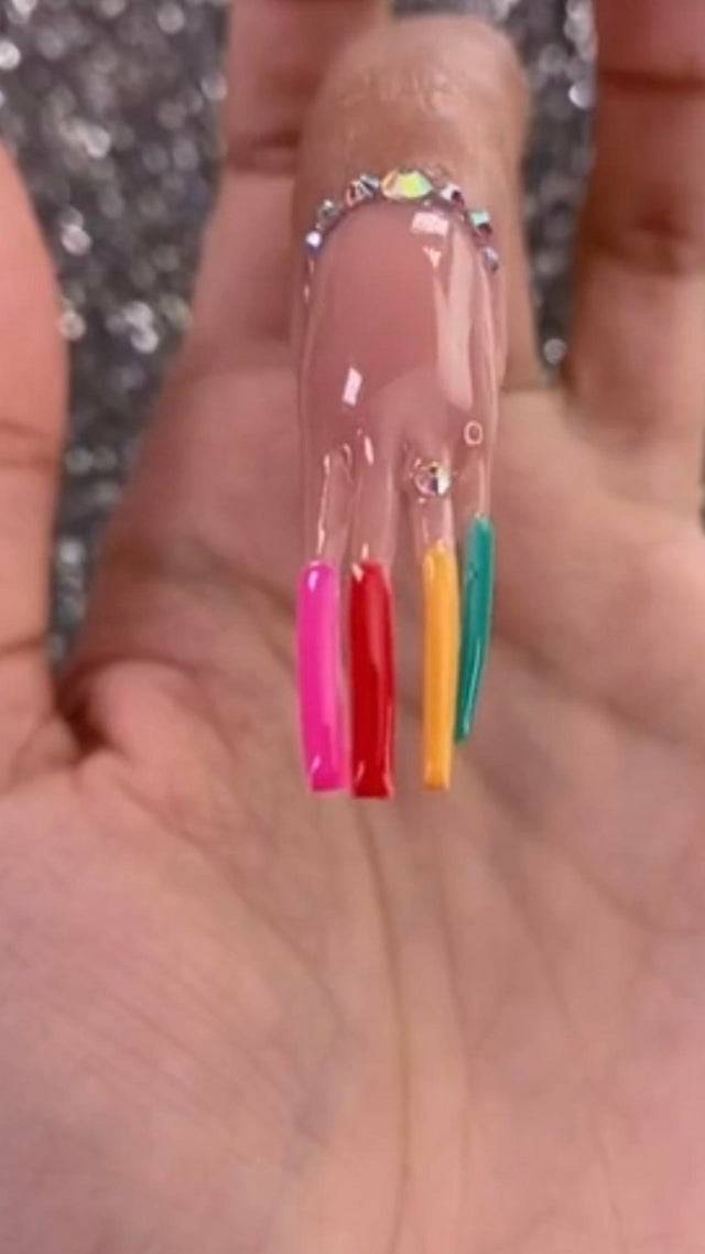 long fingernail painted to look like it's four different long, skinny nails
