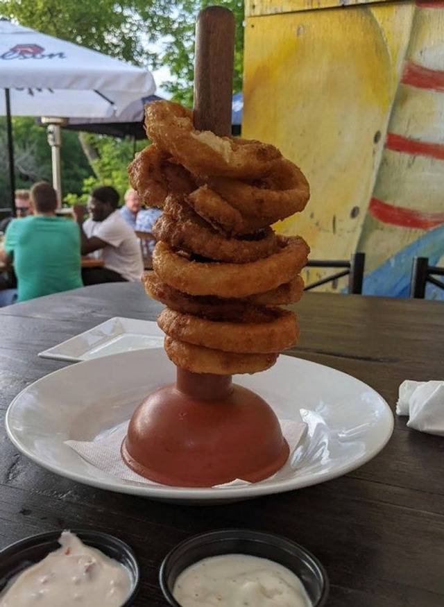 plunger connected to plate with onion rings stacked on the handle