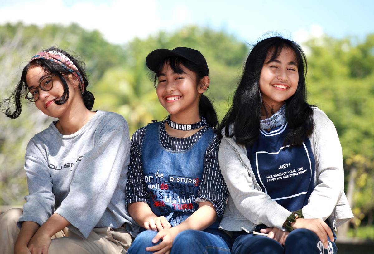 three girls sitting outside