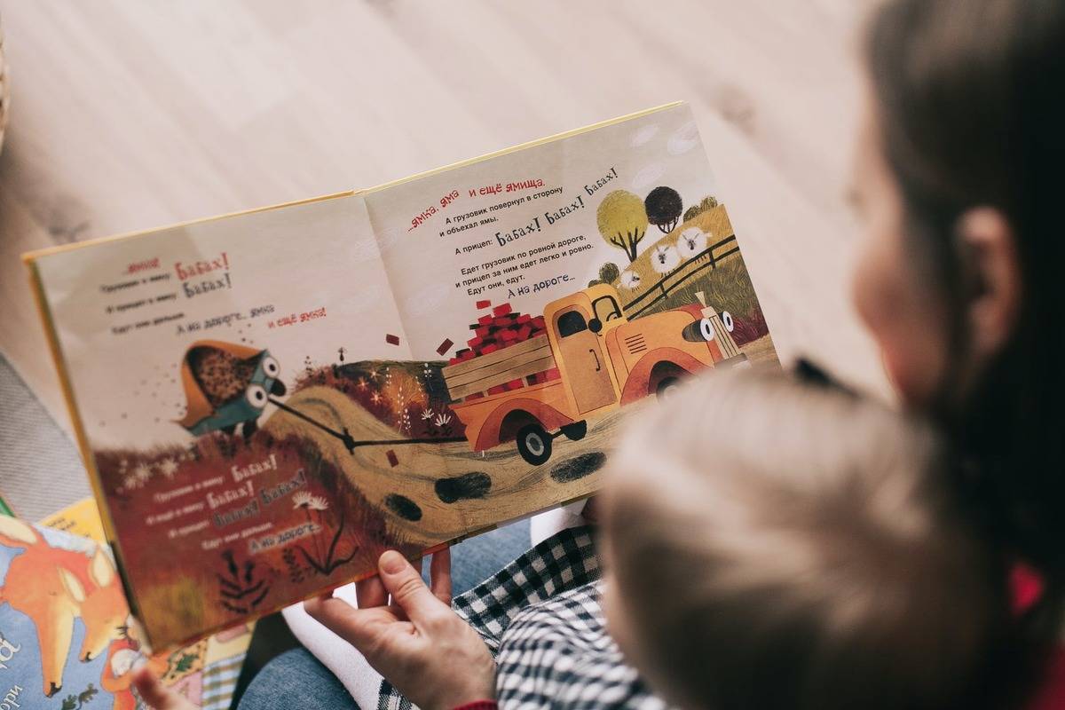 person reading to child 