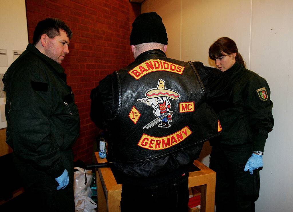 Policemen surround a member of the biker group 'Bandidos'