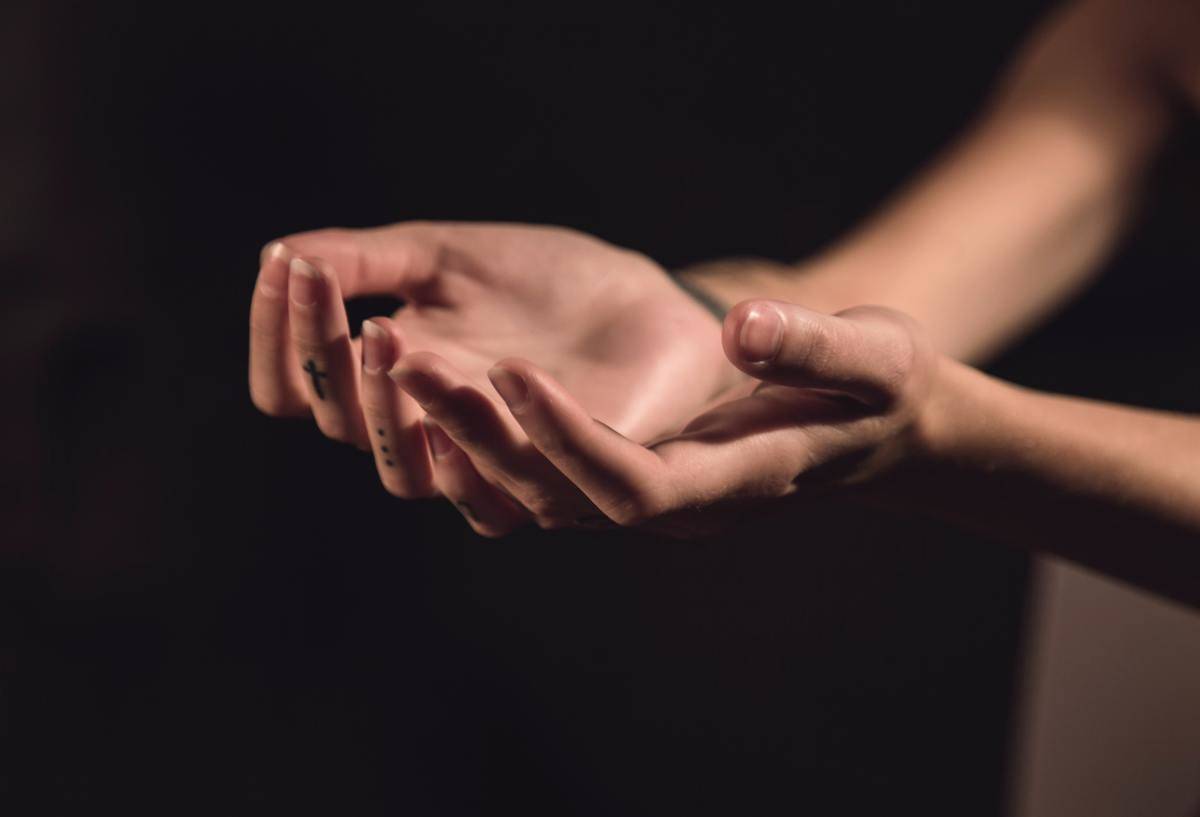 a person holding out their hands with palms facing up
