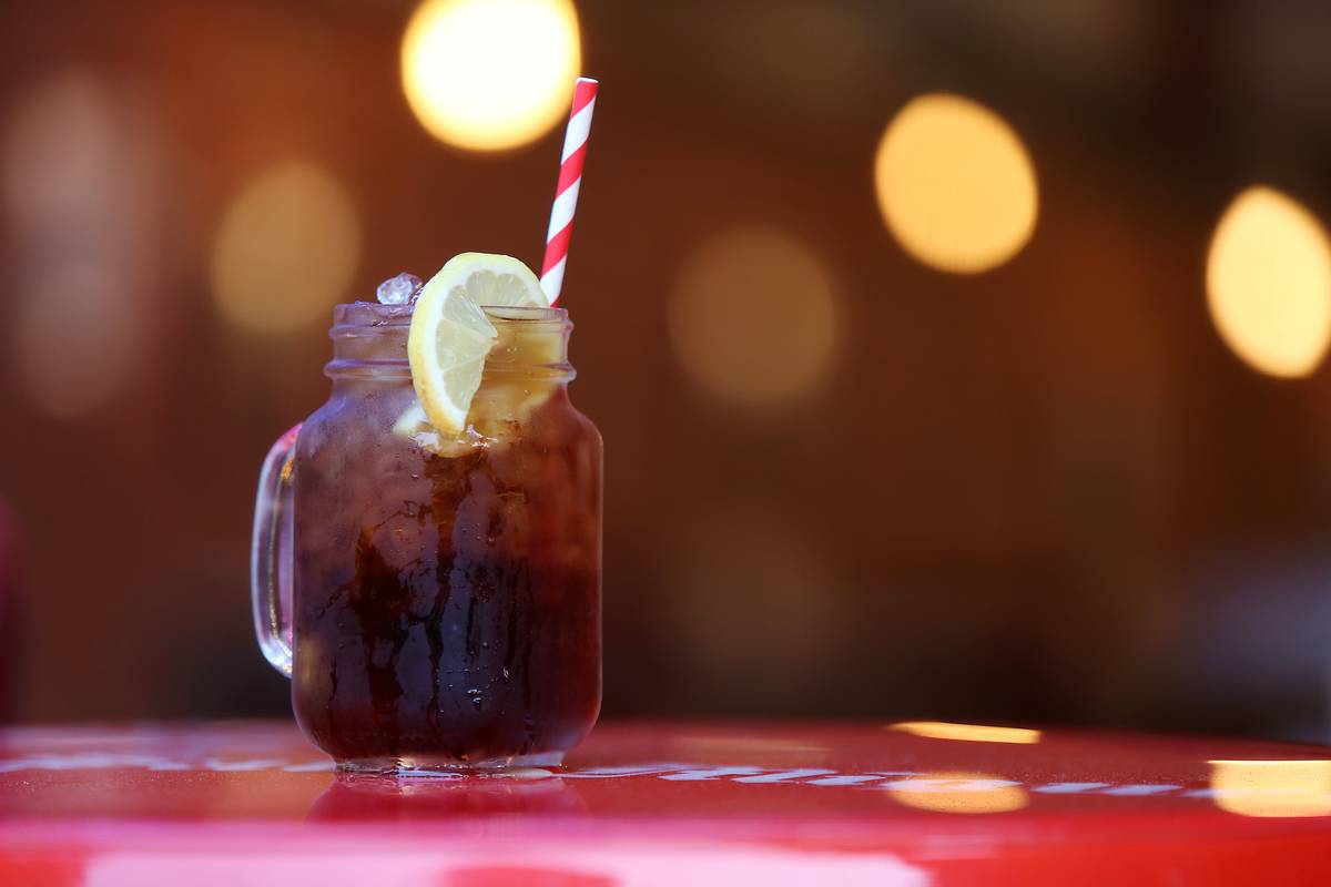 Texas sweet iced tea is in a mason jar with a straw.