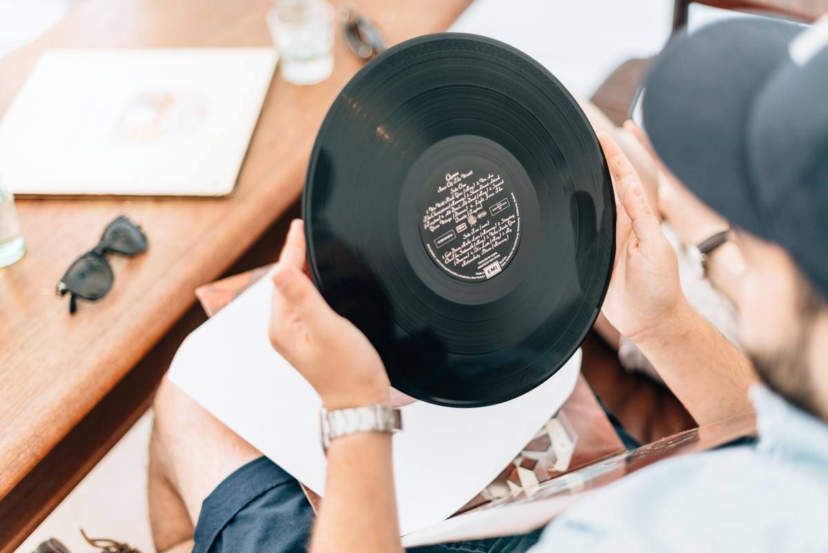 a man holding a vinyl record